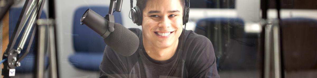 Student with headphones talking with microphone