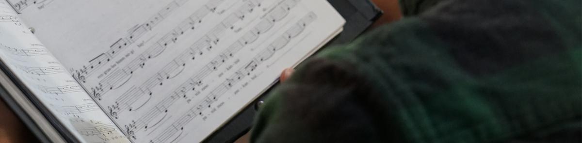 Student reading choir music