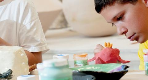 child making clay sculpture
