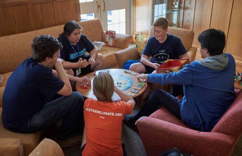 FLI attendees play a board game in the dorm