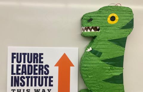 FLI directional sign with dinosaur pinata