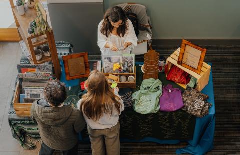 Group of visitors at a booth at the small press fair