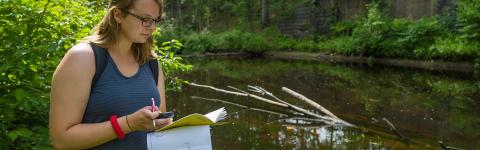 student researching on river