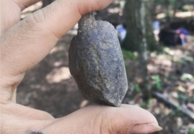 pic of a stone fragment held in someone's hand