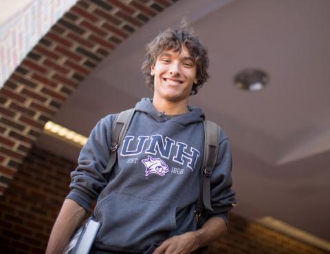 student in doorway of UNH campus building