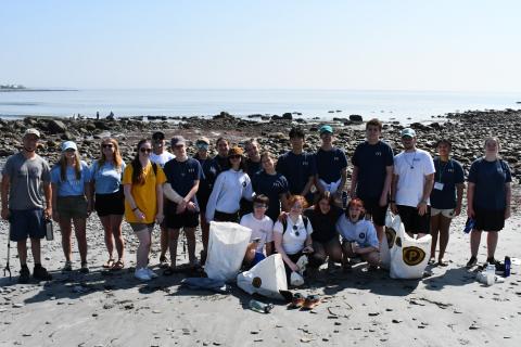Group of Climate Action volunteers cleaning the beach.