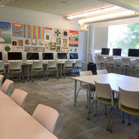 Interior of design lab classroom with computers and desks at UNH