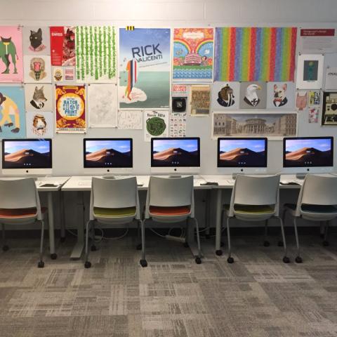 Interior of design lab with computers and colorful posters