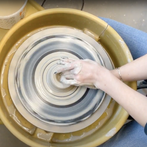 Person working at the potter's wheel