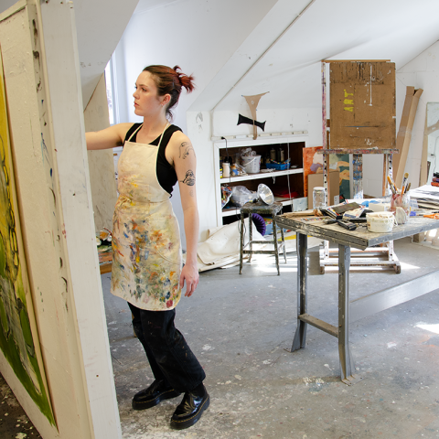 Art student standing and working in her studio