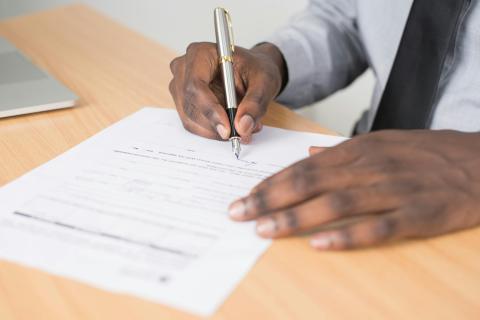 Hands filling out an application