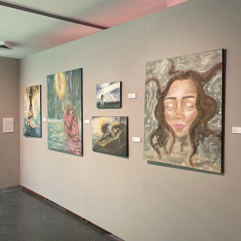 Interior of UNH Gallery of Art with paintings hung on wall
