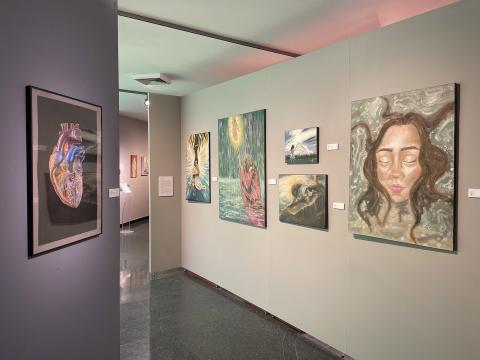 Interior of UNH Gallery of Art showing paintings by BFA graduate Lily Dube