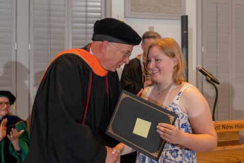 PBK Inductee Summer Sofia Shiflett is congratulated by College of Professional Studies Dean Mike Decelle at UNH Manchester’s Spring 2026 Honors Convocation