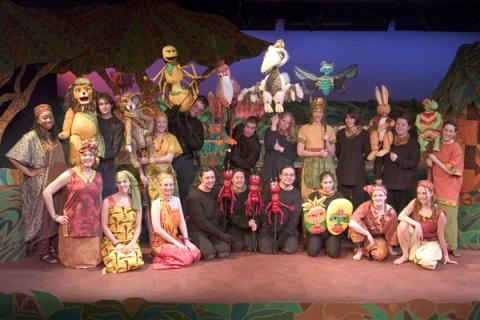 student actors and puppets on stage
